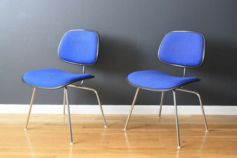 This is a set of four vintage Herman Miller chairs designed by Charles Eames with the original blue upholstery.