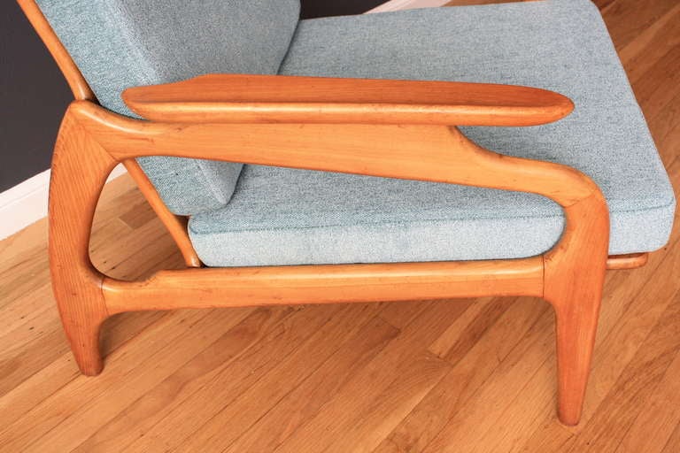 This Mid-Century Modern lounge chair was designed by Adrian Pearsall for Craft Associates, No. 1209-C. It has a sculptural frame with a cane back and has been professionally upholstered. It has new cushion inserts and new Pirelli straps.