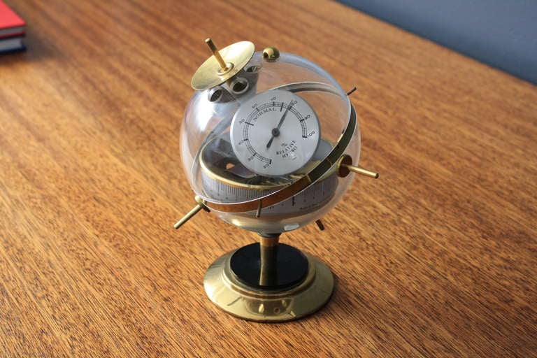 This vintage weather station barometer/thermometer can be used on a table top/desk or mounted to the wall. It is marked 