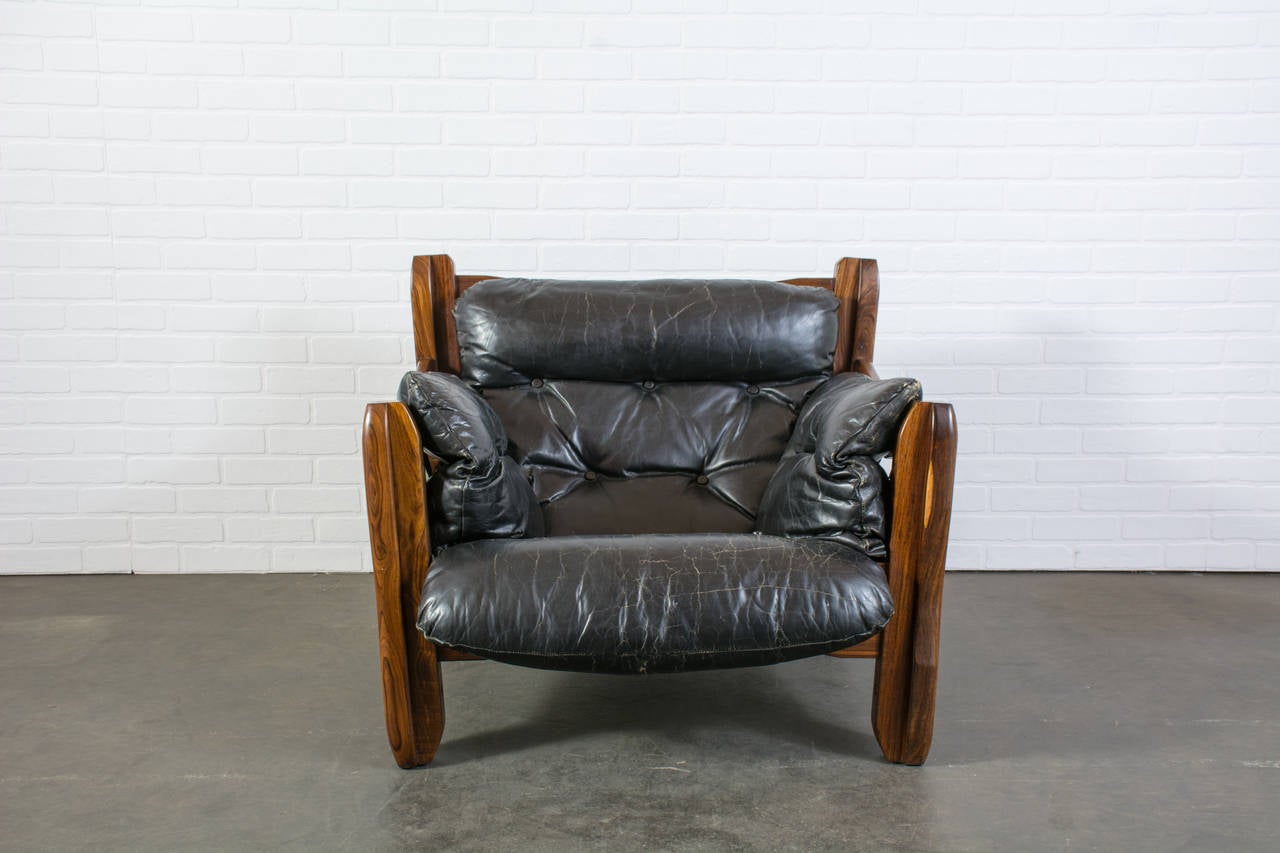 This rare vintage Mid-Century lounge chair and ottoman was designed by Don Shoemaker in the 1960s as part of his Descanso line. It features a cocobolo frame and the original black leather upholstery. Matching loveseat sofa also available.