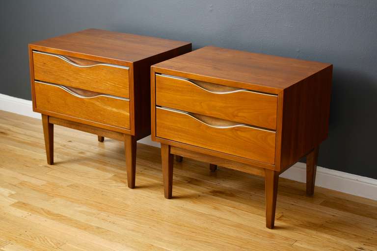 This is a pair of Mid-Century Modern night stands by American of Martinsville.  They are walnut with gold metal accents on the drawers.