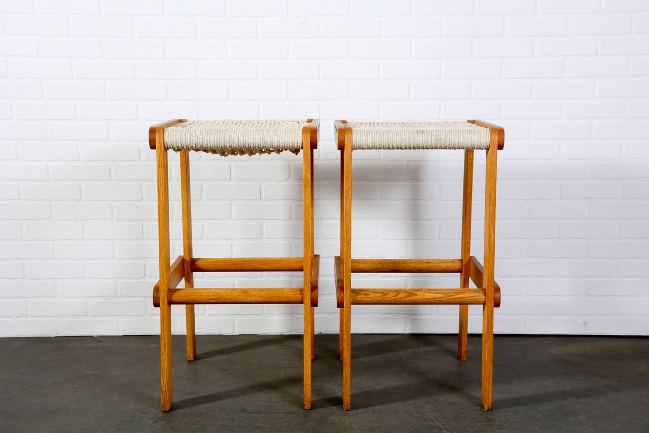 This is a pair of vintage Midcentury bar stools with oak frames and rope seats.