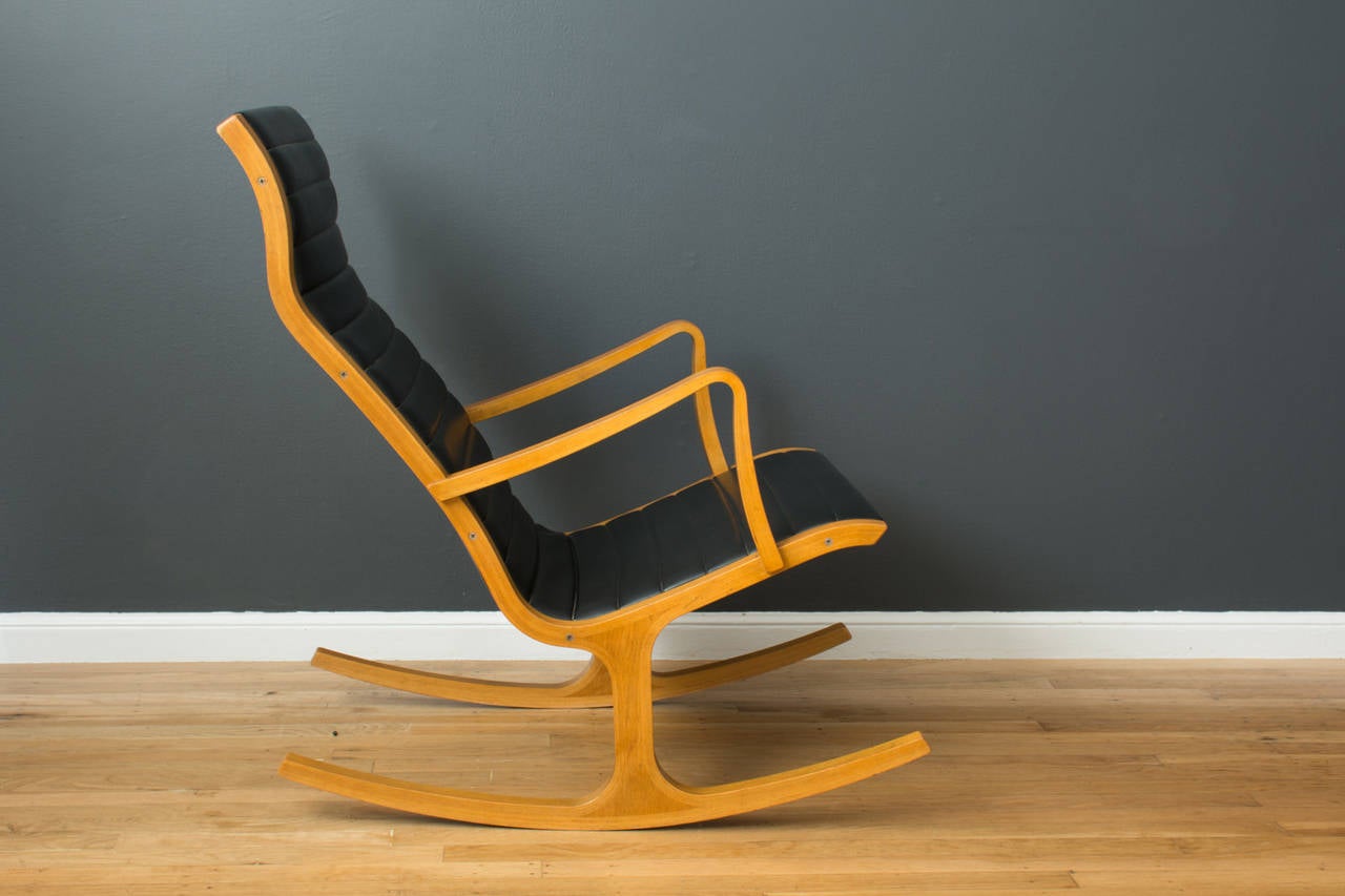 This Mid-Century Modern rocking chair was designed by Mitsumasa Sugasawa for Tendo Mokko in 1966.  It has a bent wood frame and the original black naugahyde upholstery.