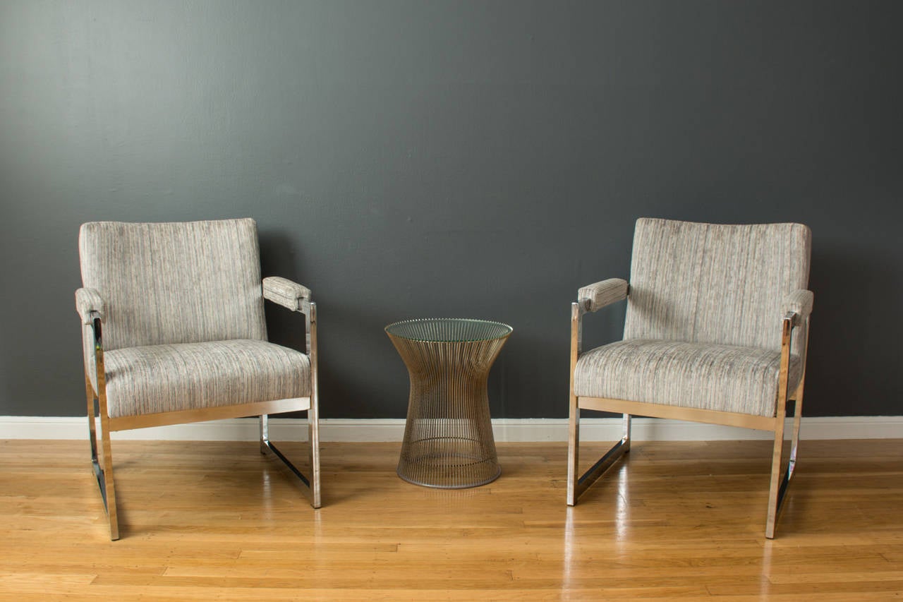 This is a pair of Mid-Century Modern lounge chairs with chrome frames and new upholstery. They are in the style of Milo Baughman.