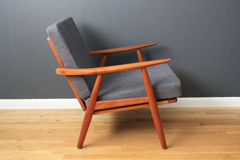 This is a vintage Mid-Century lounge chair by Hans Wegner for Getama, Model GE-270.  It has a teak frame and professionally reupholstered cushions.