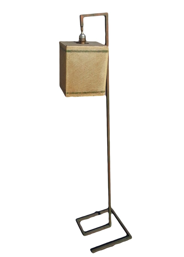 This rare Donald Deskey floor lamp features a minimal, geometric  cold-painted steel frame. The lamp comes with a boxy parchment shade which compliments the design of the lamp. Manufactured by Deskey-Vollmer Inc in New York, the lamp is one of only