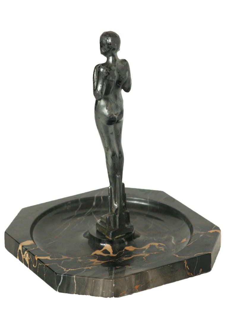 Marble ashtray/ringtray with a nude spelter metal female statue by Frankart, circa 1928.

The nude female statue original comes from a bookend made by the Frankart Metal Works company sold in 1928 and has been added to this circa 1920 marble