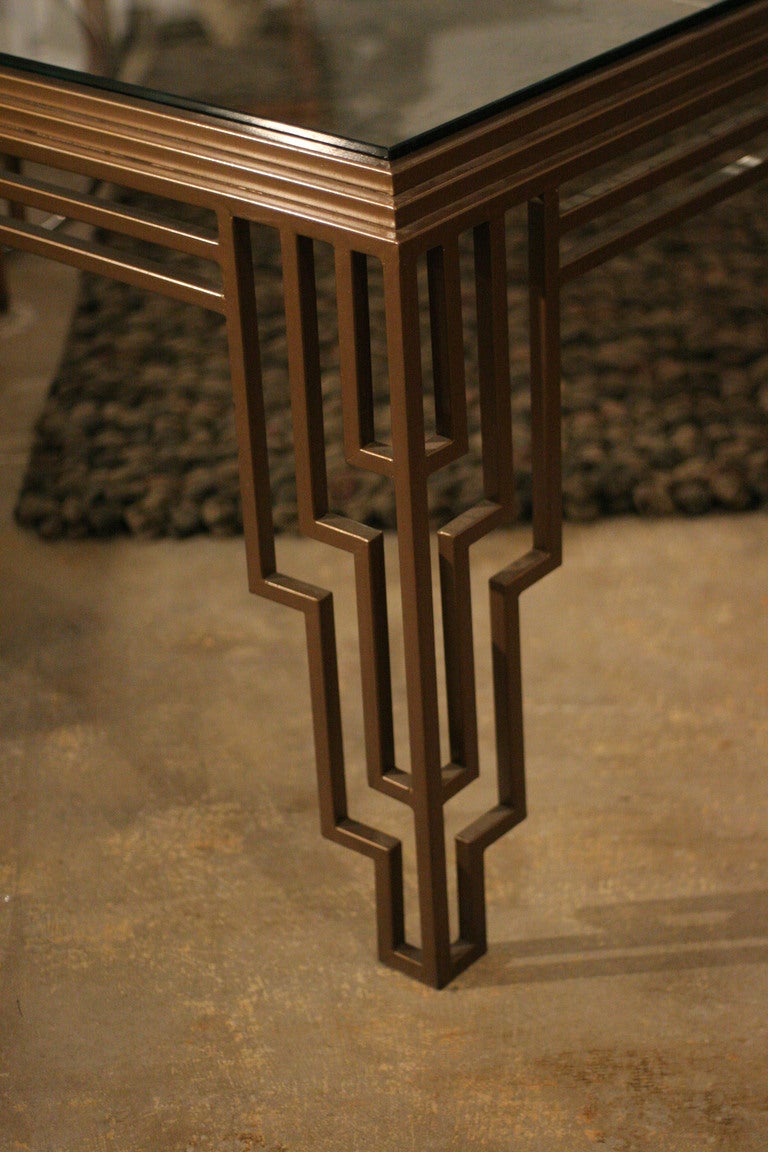 This Art Deco style dining table / desk features a stepped geometric frame inset with a thick glass top.