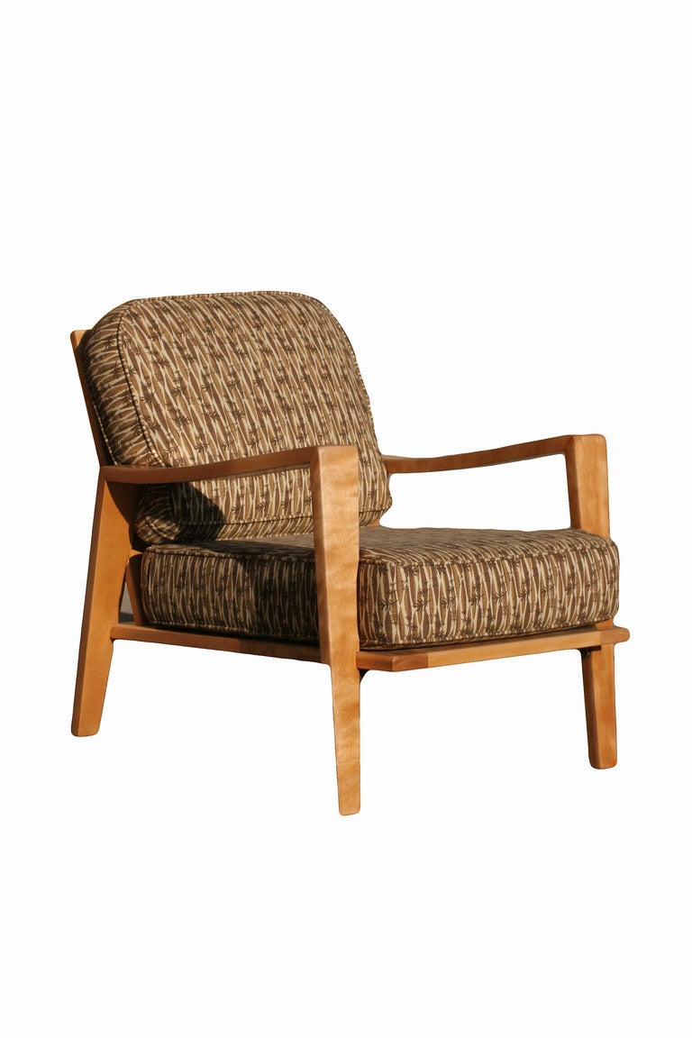This pair of Russel Wright lounge chairs for Conant-Ball are constructed in natural American maple and feature square arms, tapered legs, slatted backs and spring-supported seats. The loose cushions have been newly reupholstered in a fun,