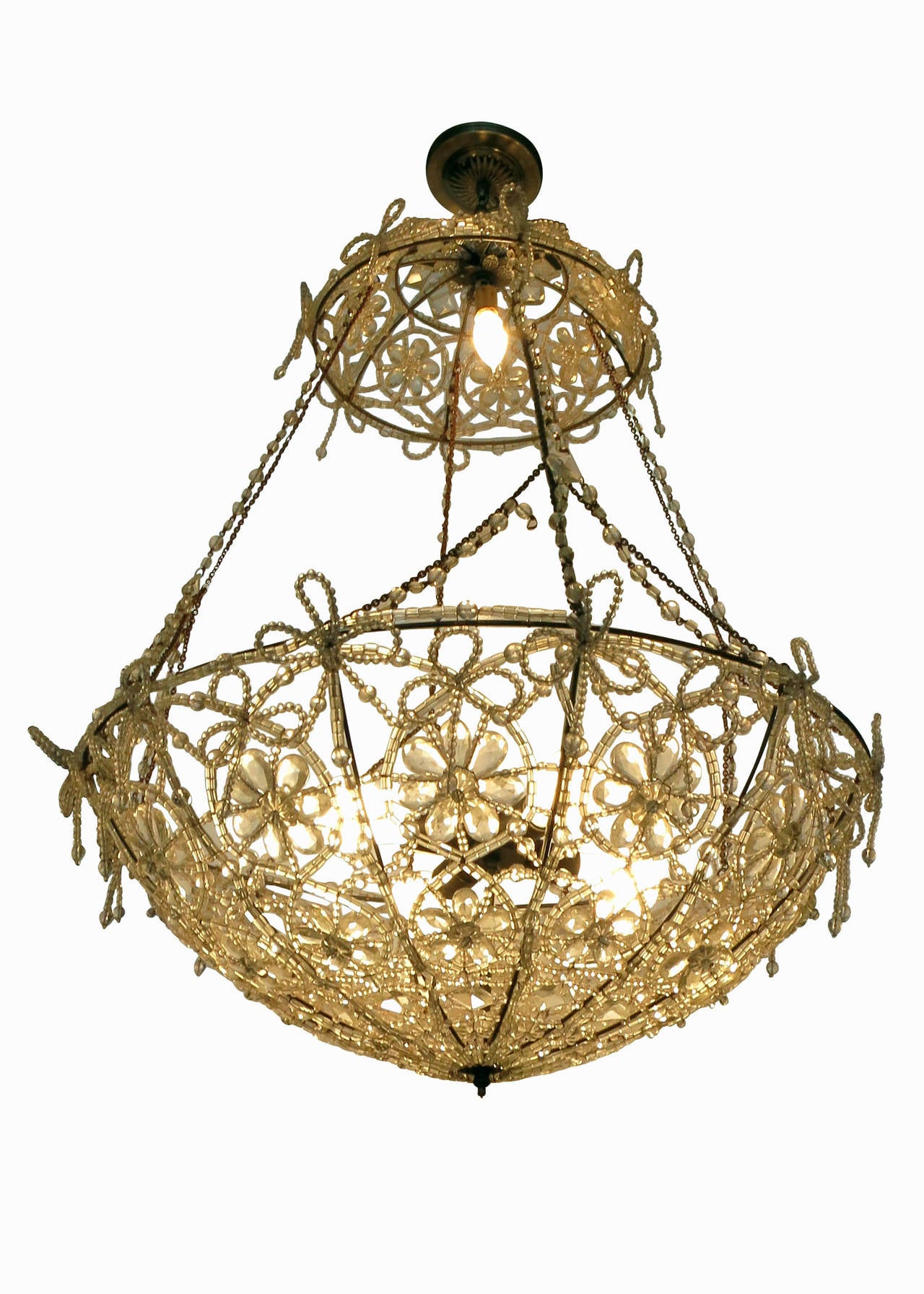 This piece is a Hollywood Regency style large beaded basket chandelier with beaded chain supports. The chandelier features a unique floral pattern made with hundreds of hand beaded wire threads. A beaded leaf clover with a drop of graduated beads