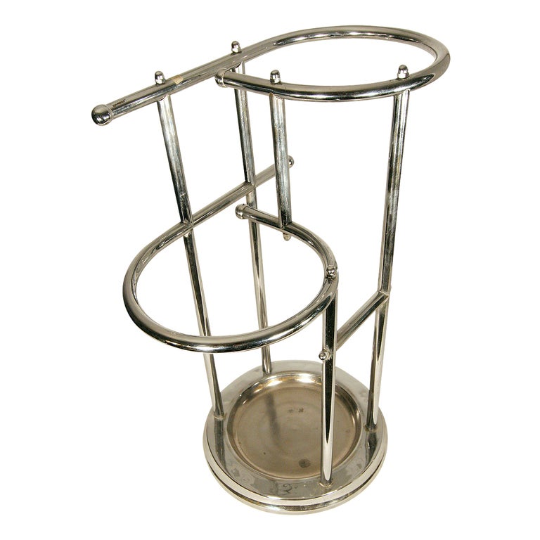This Art Deco umbrella / cane stand in chrome was clearly influenced by the Bauhaus aesthetic and features two circular enclosures to help keep items organized.