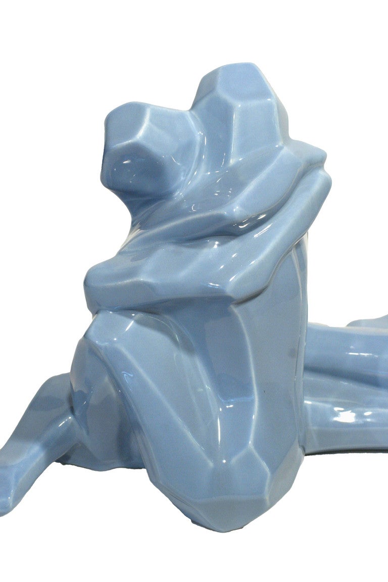 The Cubist inspired rendering of entwined lovers was produced by Jaru in the late 1970s. The ceramic sculpture is hollow inside and finished with a cornflower blue glaze. It is an excellent example of California pottery. Inscribed into the base is a