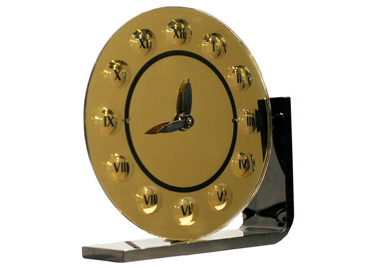 Art Deco bent black glass and gold mirrored glass clock by the New Haven Clock Company of Los Angeles.

New Haven Clock Company New Haven Connecticut 1860 to 1960