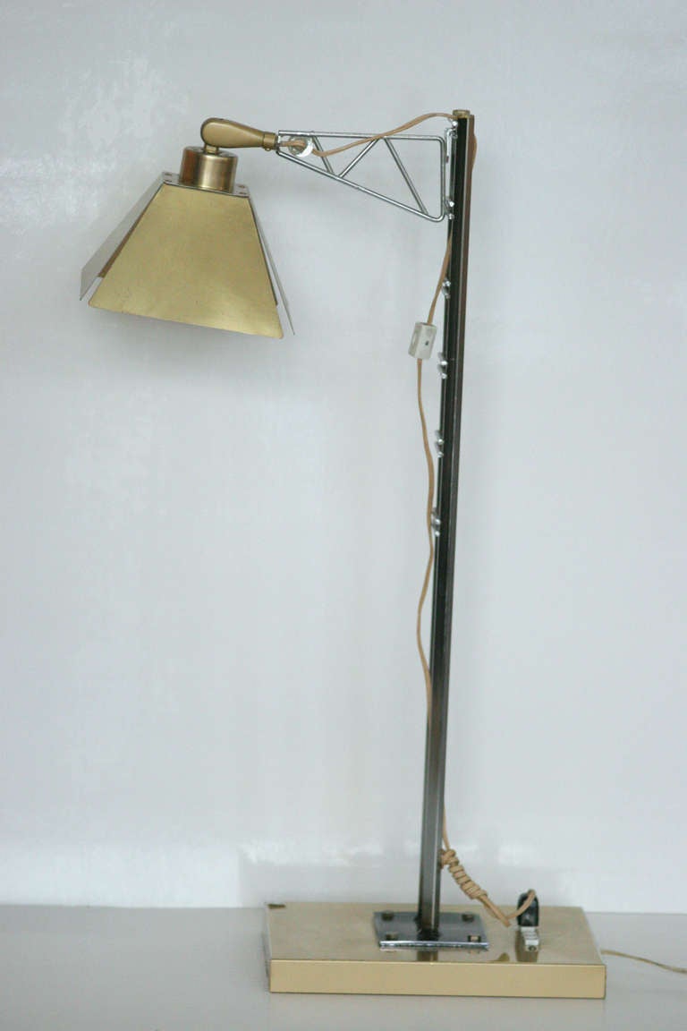 Curtis Jere designed table lamp, circa early 1970s. Features adjustable brass shades with chrome body and square brass base.

We nicknamed it the 