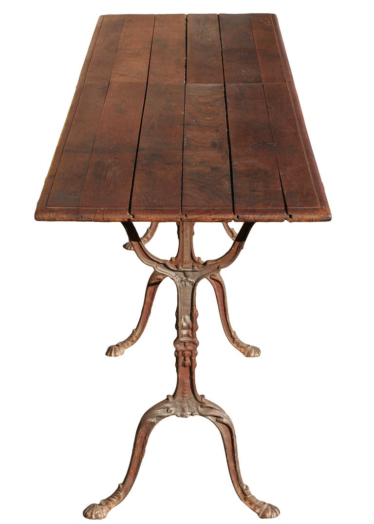 This fantastic example of late 19th century provincial French furniture is as utilitarian as it is attractive. The intricate cabriole legs rendered in iron are connected by strapping in the same material supporting the aged wood surface. Because of