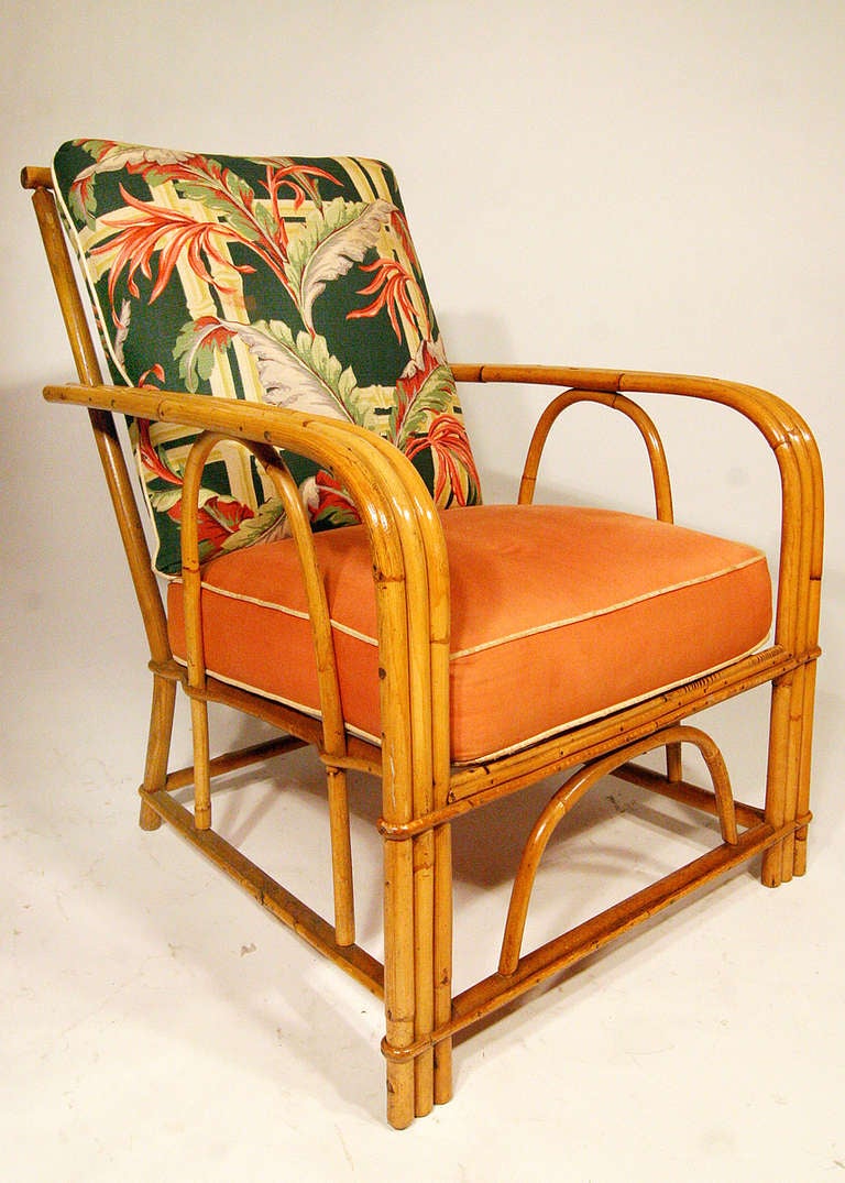 Vintage 3 strand bent Oak and Rattan armchair with arching sides by Heywood Wakefield. The Bark Cloth cushions are original and can be re-upholstered.

All Rattan has been Painstakingly Refurbished Using the Finest Materials By Master Craftsman