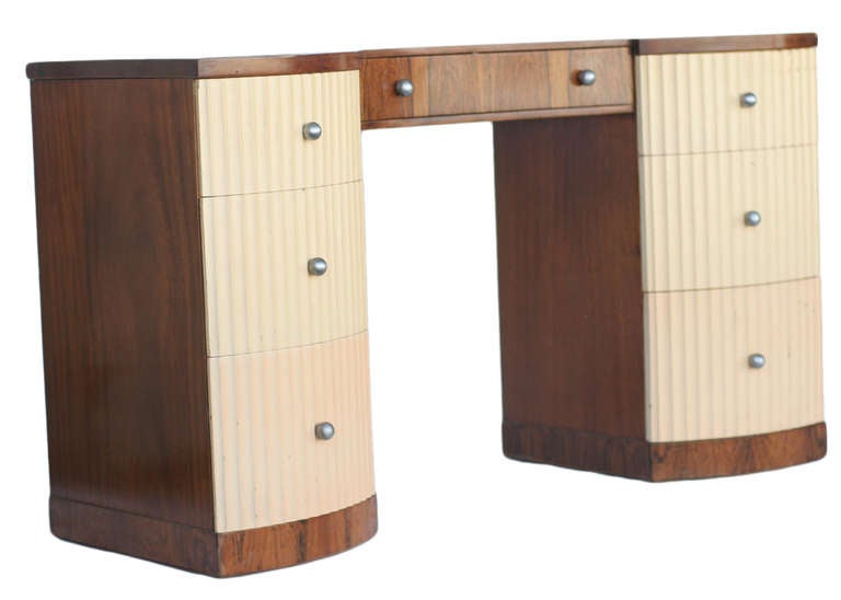 Paul Frankl demilune vanity/desk with sculpted combed wood drawers. Vanity features three side drawers on each side and a center pull-out drawer.