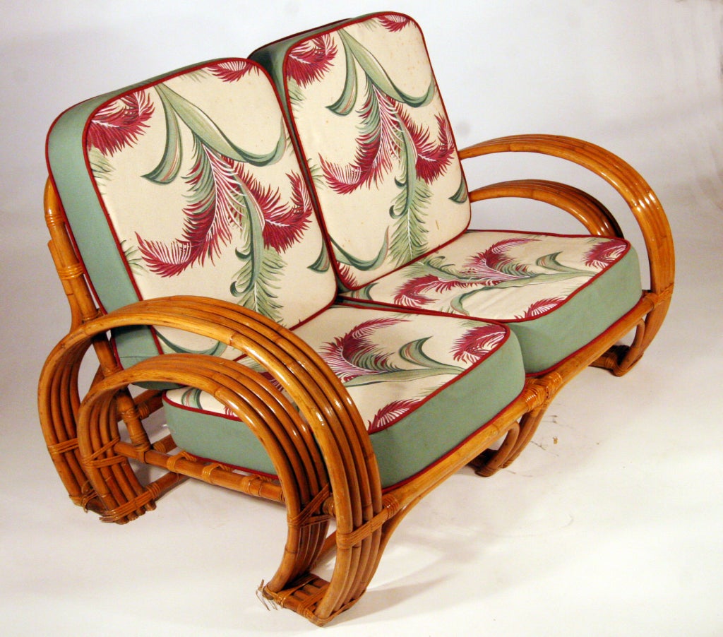 Designed in the manner of Paul Frankl, this 1940s four-strand rattan settee features 