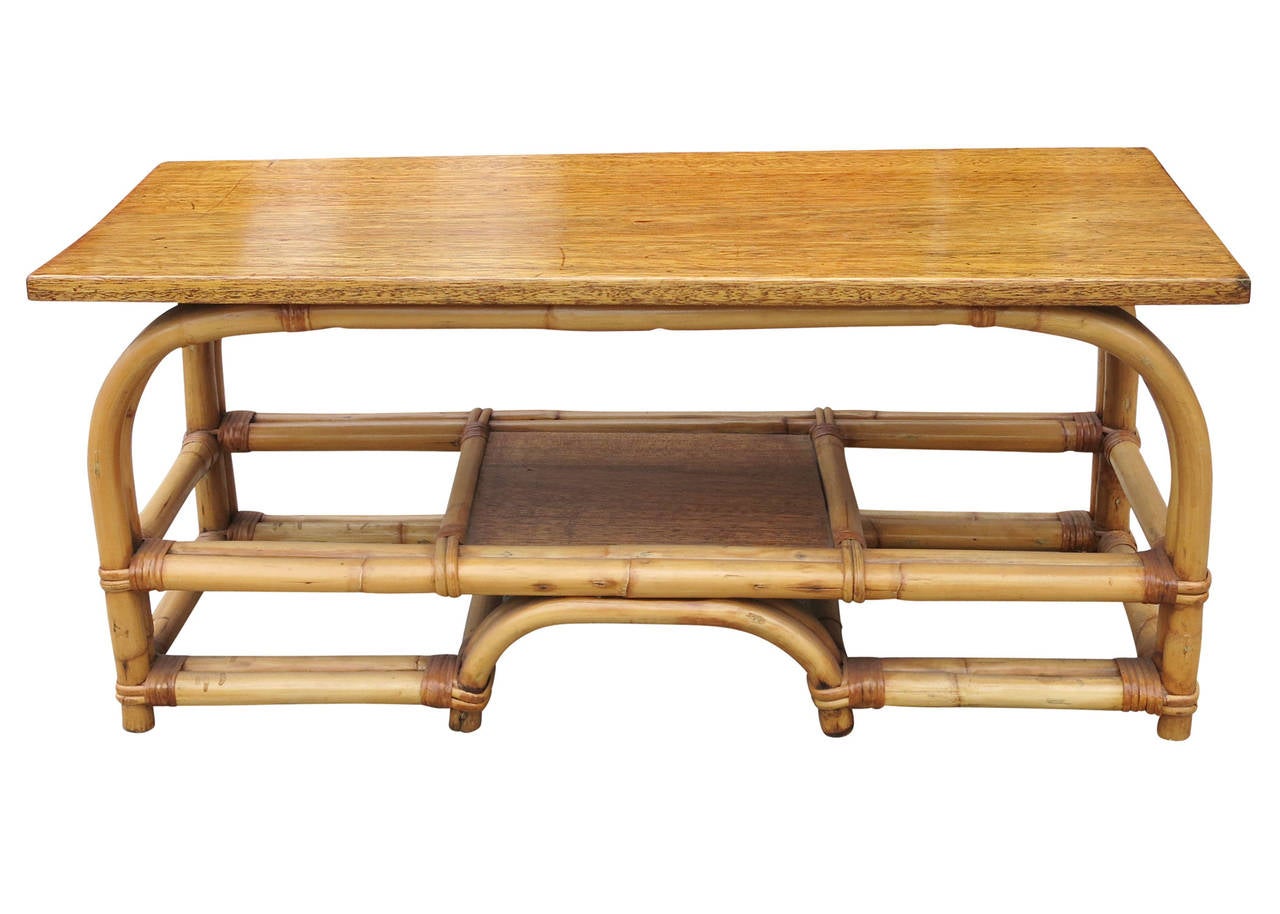This piece is a vintage 1940s rattan coffee table with wonderful bentwood base and stylized arches built in. It also has a beautiful mahogany top.

This table is sure to grab attention as a wonderful center piece in any room.

Also available are a