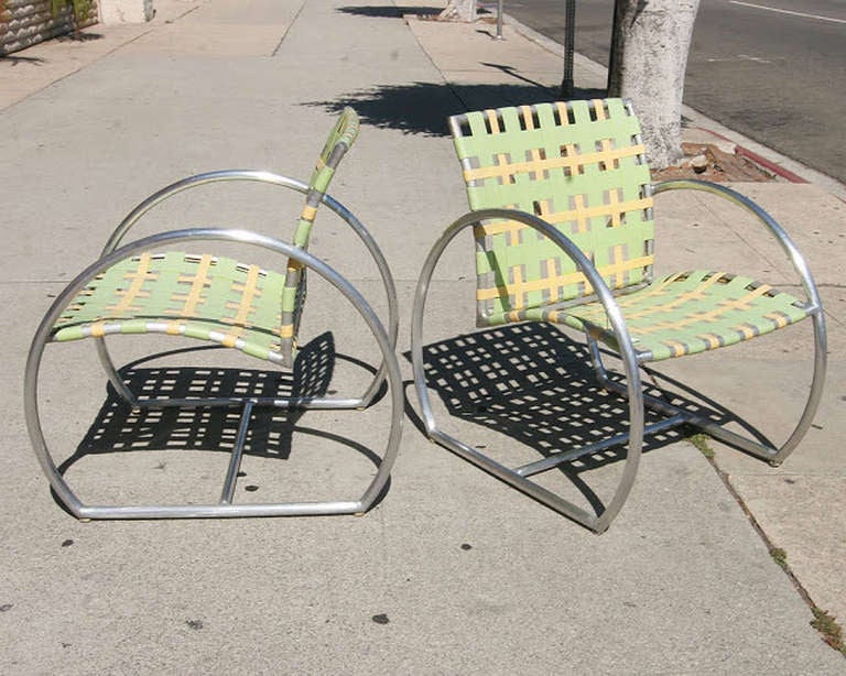 Pair of Brown and Jordan outdoor chairs by Don Kolby for the Circa Collection. The chairs feature rounded Aluminum arms and green and yellow woven seats.