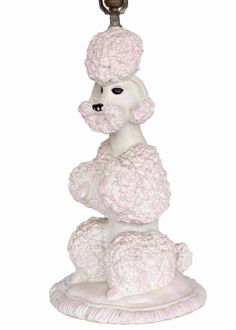Classic pink sculptural poodle lamp designed and introduced in 1953 by Phyllis Morris manufactured by W.J. Sloan's in Los Angeles. 

The poodle lamp propelled Morris into the limelight and it wasn't long before she became a local celebrity. Often