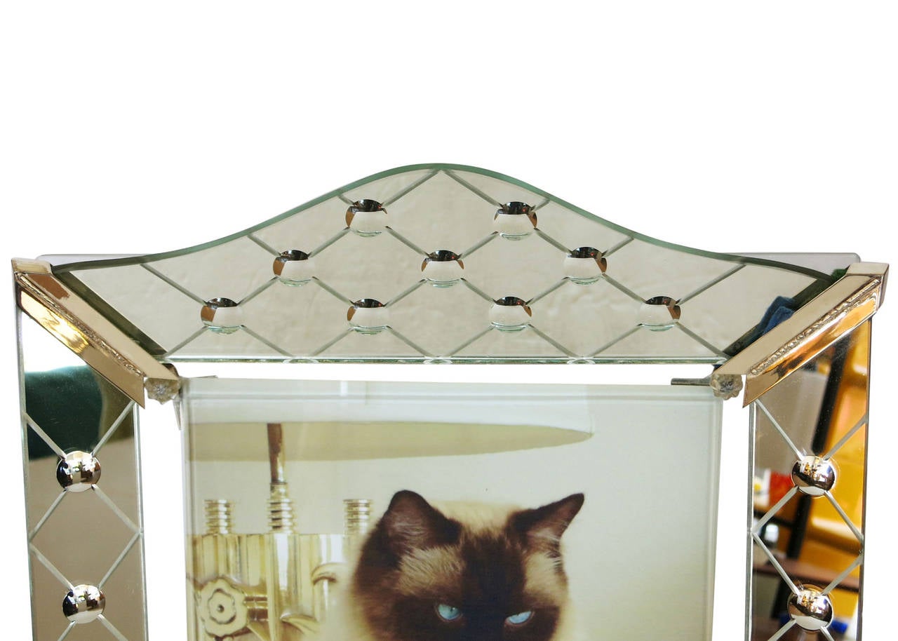 Made circa 1930, this French Art Deco table top picture frame was made entirely out of hand cut glass pieces. The pieces are held together with silver plated corner brackets. Additionally, the front bezel features a beautiful mirrored face with a