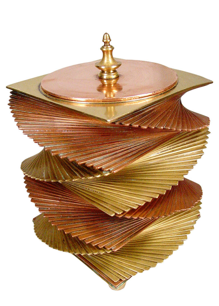 This large and very rare original 1933 cigar box was designed, patented and manufactured by John Otar in California. Individual square copper and brass plates are stacked to create a spectacular, twisting spiral form that weighs in at approximately