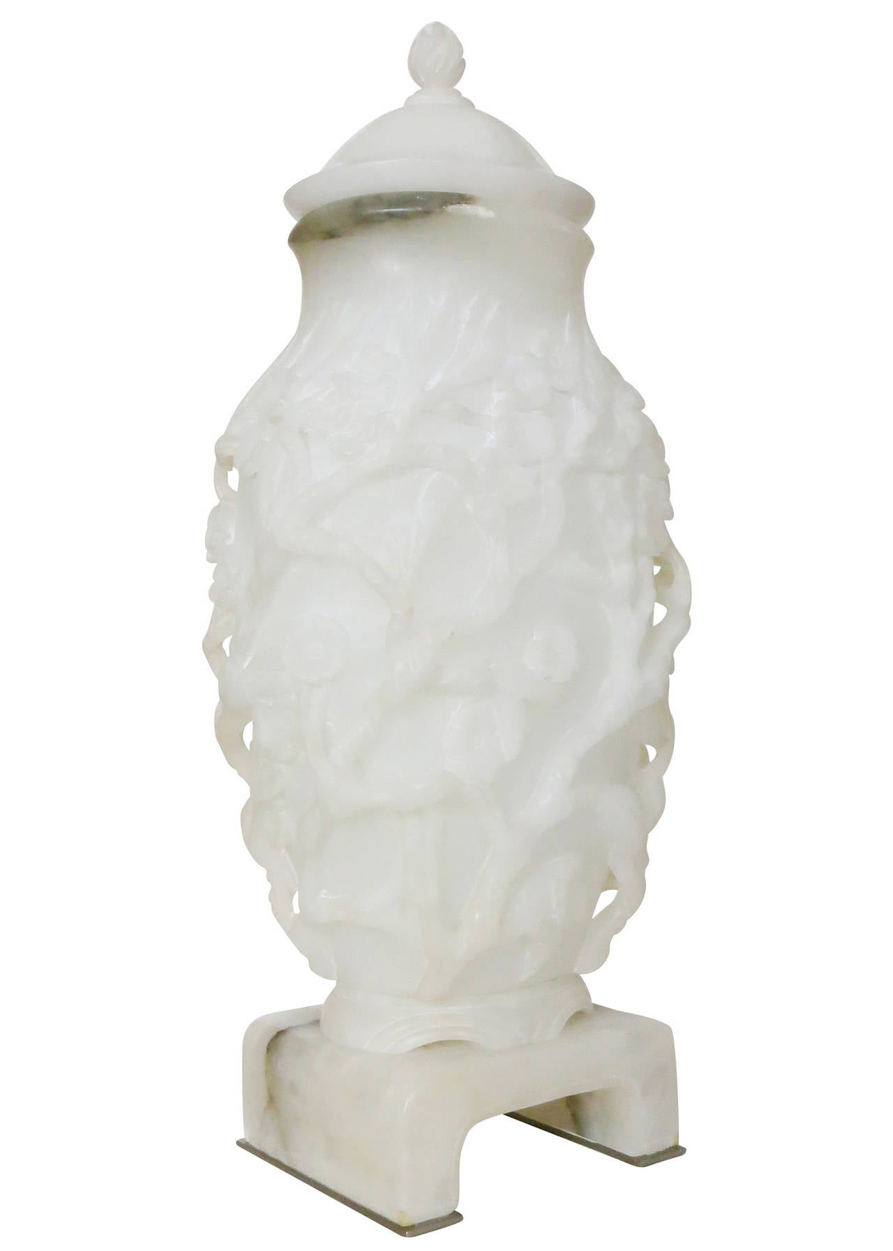 This classic Asian Urn lamp by Marbro a California company known for engaging European craftsmen to realize their designs.

This piece is handcrafted white alabaster with the classic cherry blossom motif. It rests on brushed nickel feet and is lit