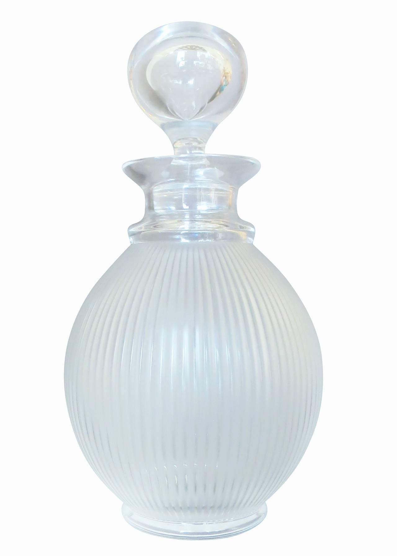 Designed and crafted in 1976 by René’s son Marc Lalique, this pattern has become iconic. Referencing both fluted antique columns and modernist architecture, it takes seven glass masters to create this decanter using the time-honored techniques of