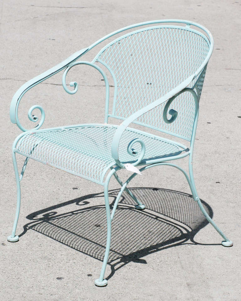 Pair of Russell Woodard designed wire frame outdoor patio chairs with scrolling pattern and mesh steel seats.

Please inquire us if you would like a different quantity of chairs. More are available upon request.