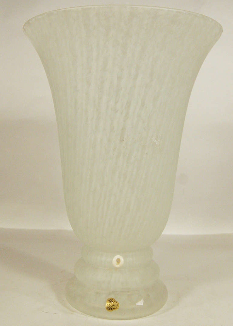 Beautiful hand blown torchiere table lamp from the Laurel Era with original tag “CVV Vianne made in France”. This lamp features a spiraling pattern around the inside of the glass.

France, Circa 1990.