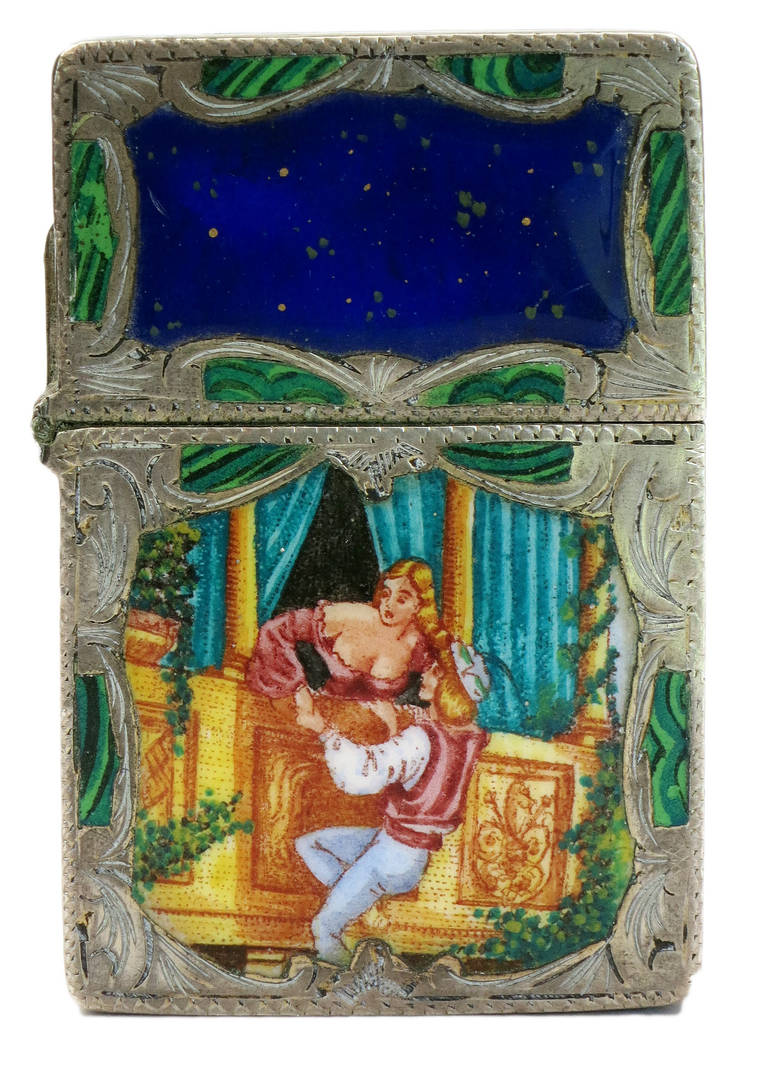 Circa 1940 Italian Sterling Silver lighter case featuring a Hand Painted Enamel scene of Romeo and Juliet with Hand Carved Etchings along the entire case and back. The lighter insert was made by Zippo of America.