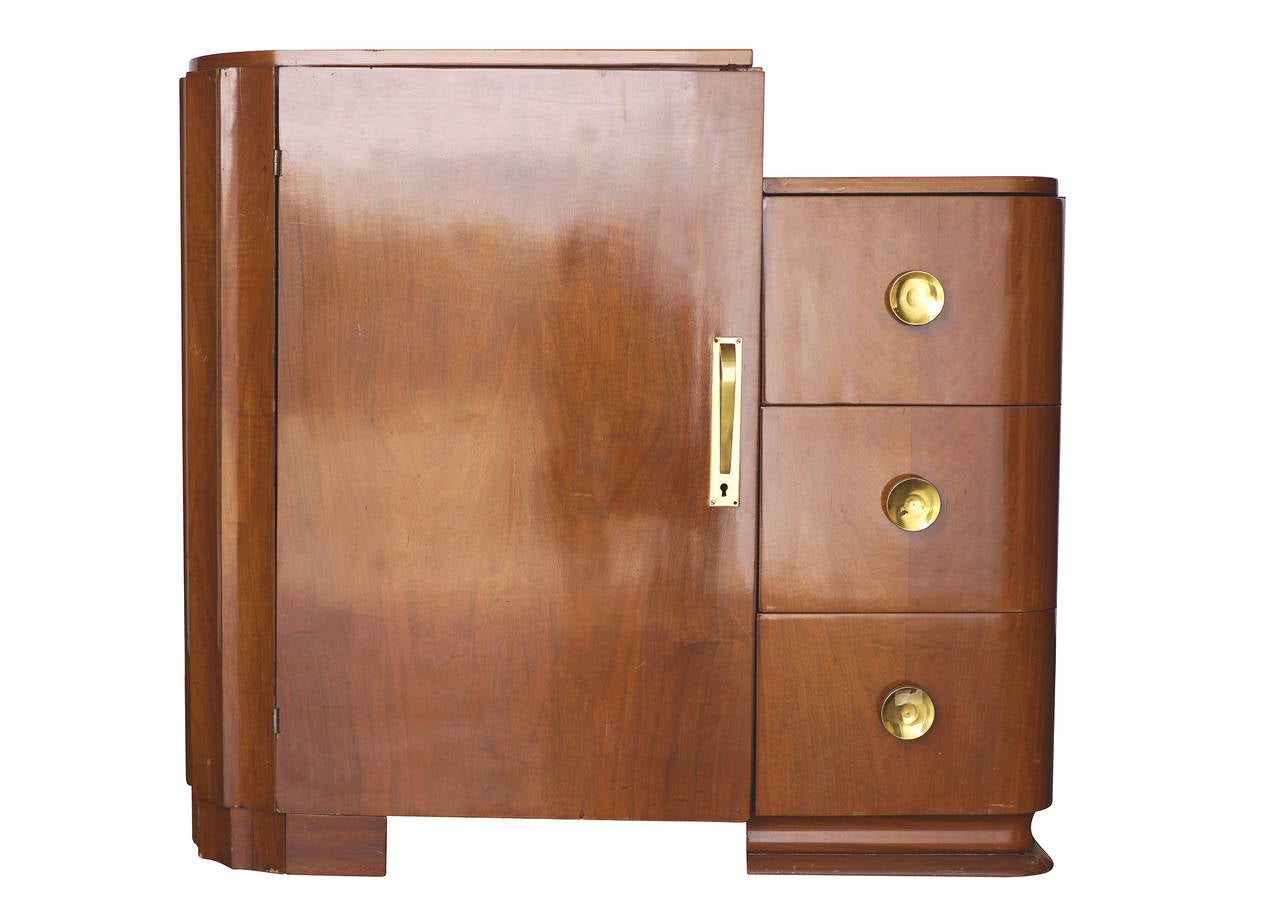 Streamline Art Deco Armoire with single door suit/dress closet and 3 drawer dresser on the side. Features brass pulls and a classic geometric Art Morderne styling with rounded edges.