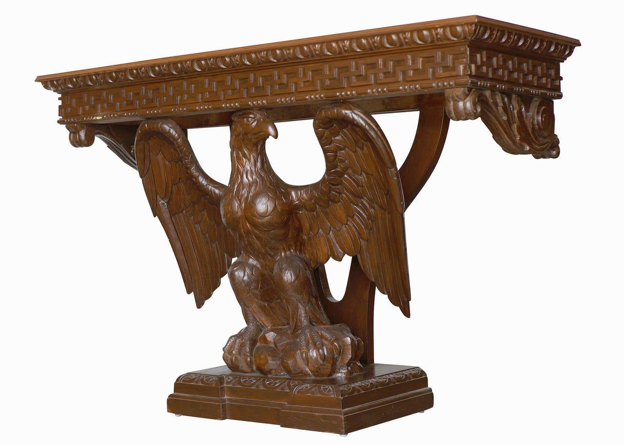 American neoclassical hand-carved console table. The rectangular oak top is supported by an eagle with spread wings holding, the tapering plinth with carved relief of Greek key and hand-carved detailing along the base.
Possibly George III
Two
