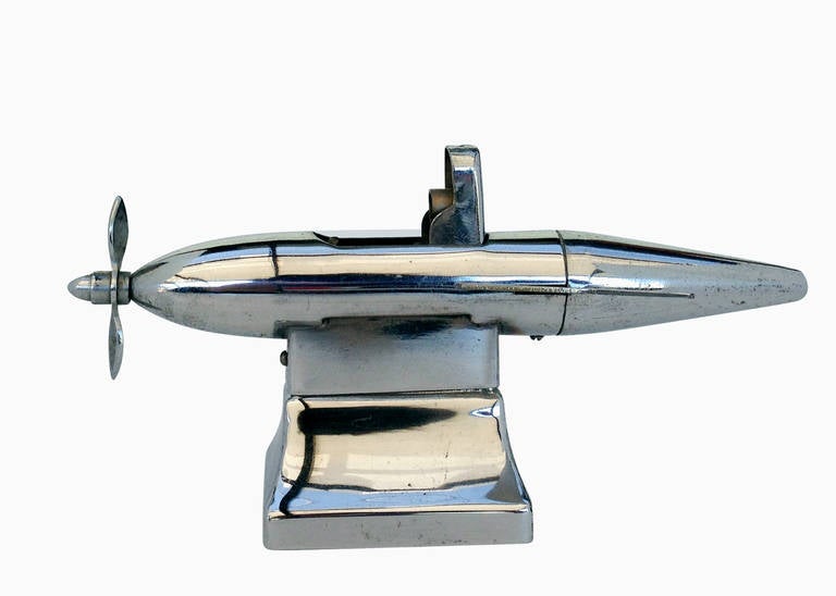 Chrome torpedo lighter with free moving front propeller and single button open and striker flit light. 

Stamped 