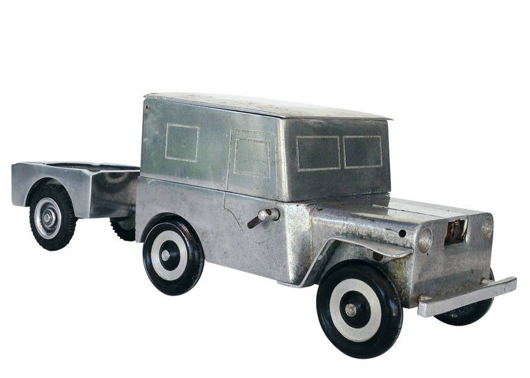 Made by the Walter Baier Company, in U.S. occupied Germany shortly after WWII, circa 1947, this post-war tabletop cigarette case, lighter and ashtray set is styled after a WWII era Ford Willy MD Jeep. The body is made from a cast block of aluminum,