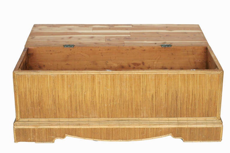 Stick rattan linen trunk with grass mat cover and cedar lined inner walls. All decorative accents have been finished with brass nails. 

Circa 1930

All Rattan has been Painstakingly Refurbished Using the Finest Materials By Master Craftsman