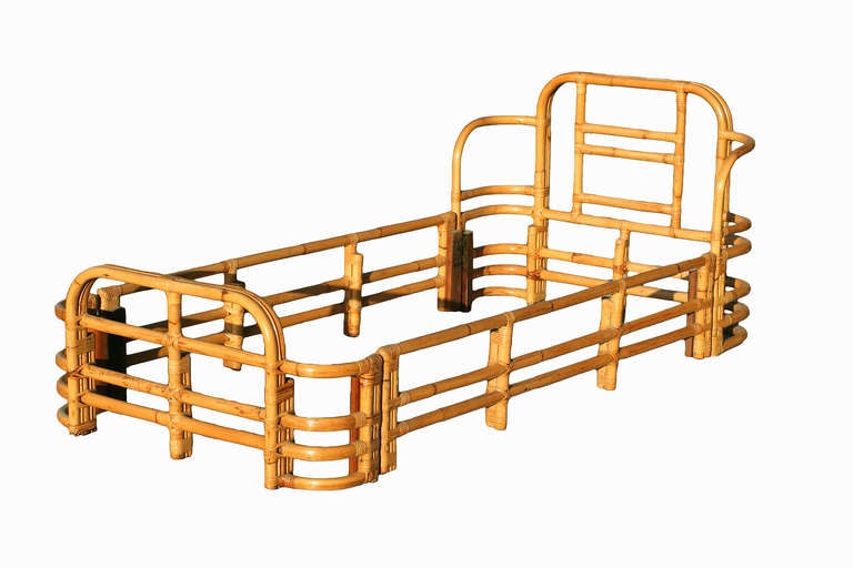 Bent pole rattan bed frame with three strand headboard and footboard. Each end has been wrapped with a wicked banding, circa 1940.

Fits single size mattress.

Headboard- 30