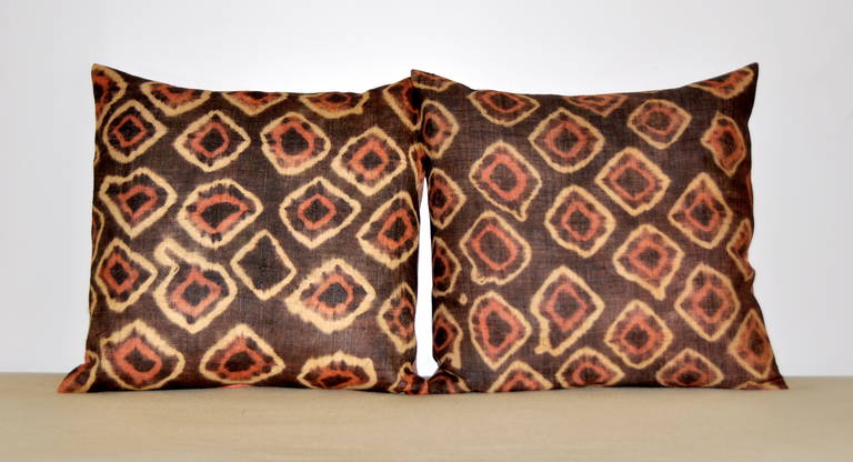 Antique African tie-dyed Kuba cloth pillow pair with Dupioni silk backing.  ... These pillows were made with antique raffia palm fiber which were tie-dyed with natural dyes. Hand woven panels were used as ceremonial dance skirts by the Ngongo tribe