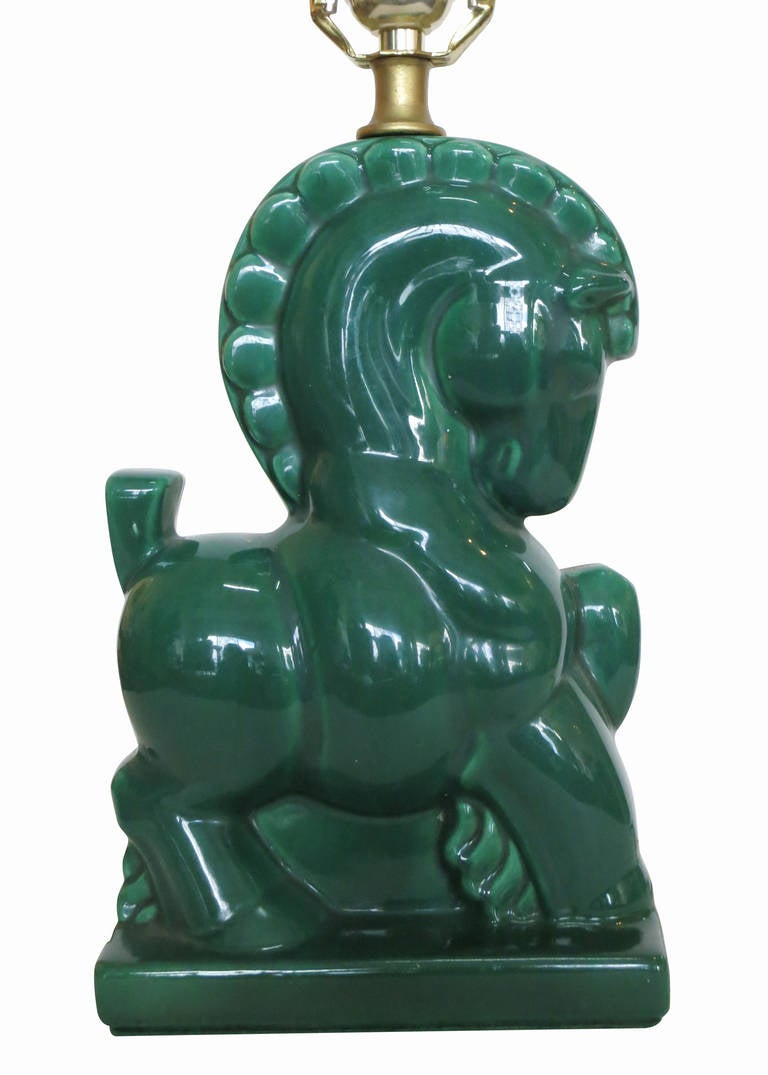 This set of Mid-Century era green table lamps pair features two emerald green horses, highly detailed with a playful styling.