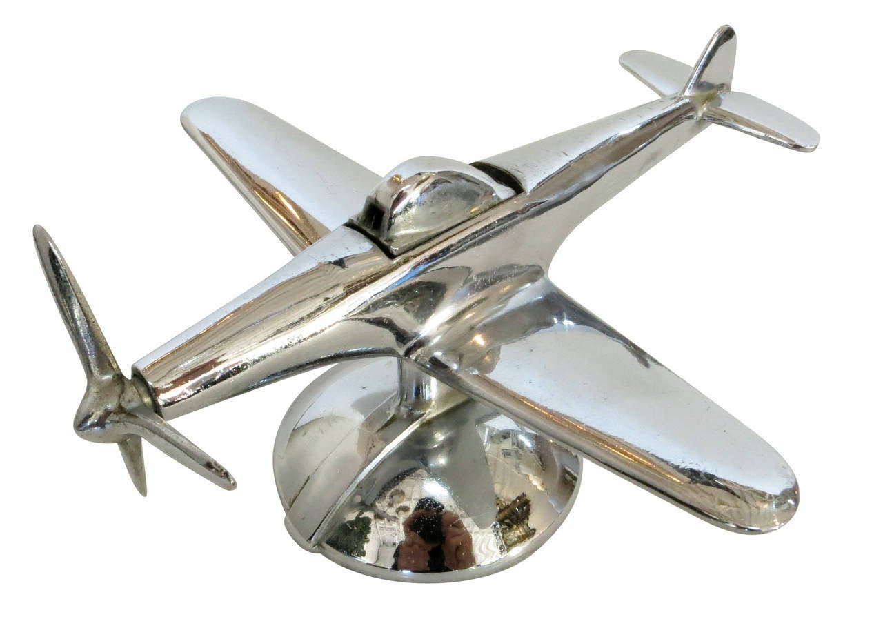 Mid-Century era Negbaur made desktop airplane lighter modeled after the North American P-51 Mustang II fighter plane used heavily in WWII. This Lighter features a chrome-plated metal body and simply modernist design.

Upon turning the propeller
