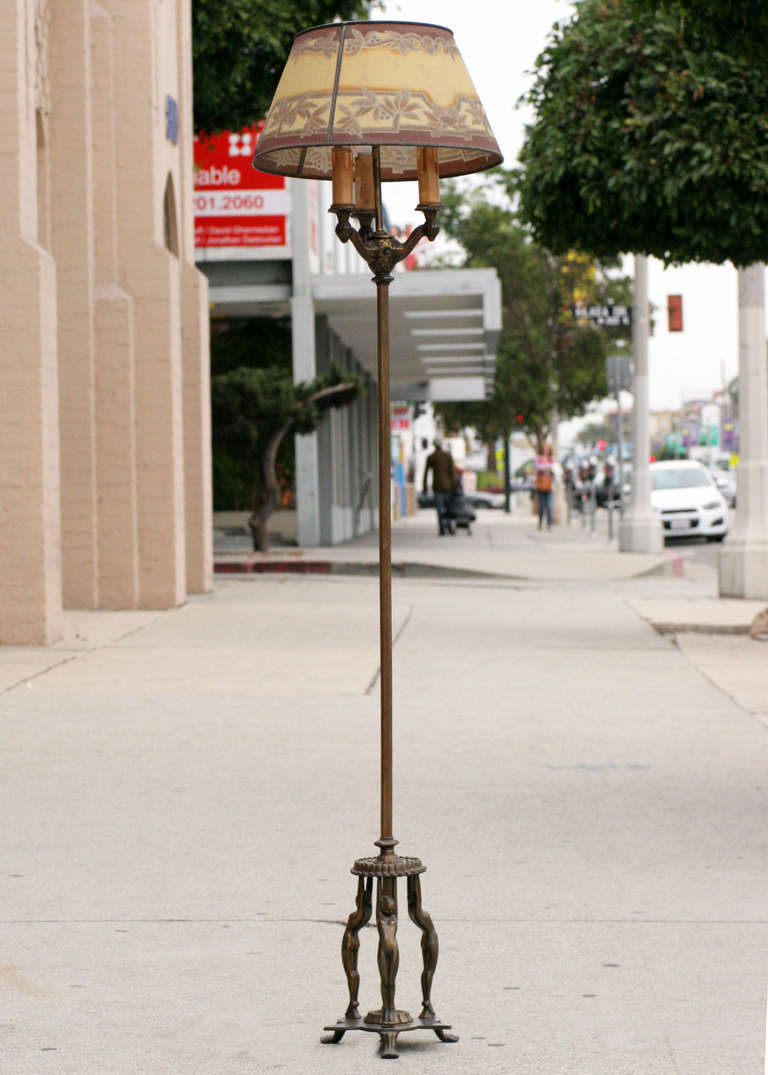 Super rare 1930s Frankart floor lamp with a base featuring three nude nymphs. Made of cast iron, brass and brass-plated parts.

The lamp comes with a 1920s period decorated metal lamp shade.

Frankart Inc.

Arthur Frankenberg began designing