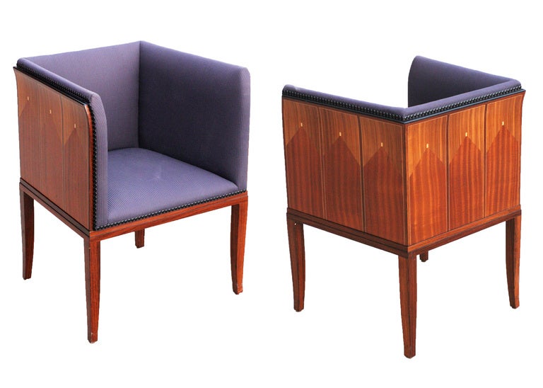 These magnificent arm chairs were originally designed in 1929-1930 by Eliel Saarinen (1873-1950) for his home on the Cranbrook Academy campus shortly before becoming president of the institution. The chairs represent a classic pairing of the elder