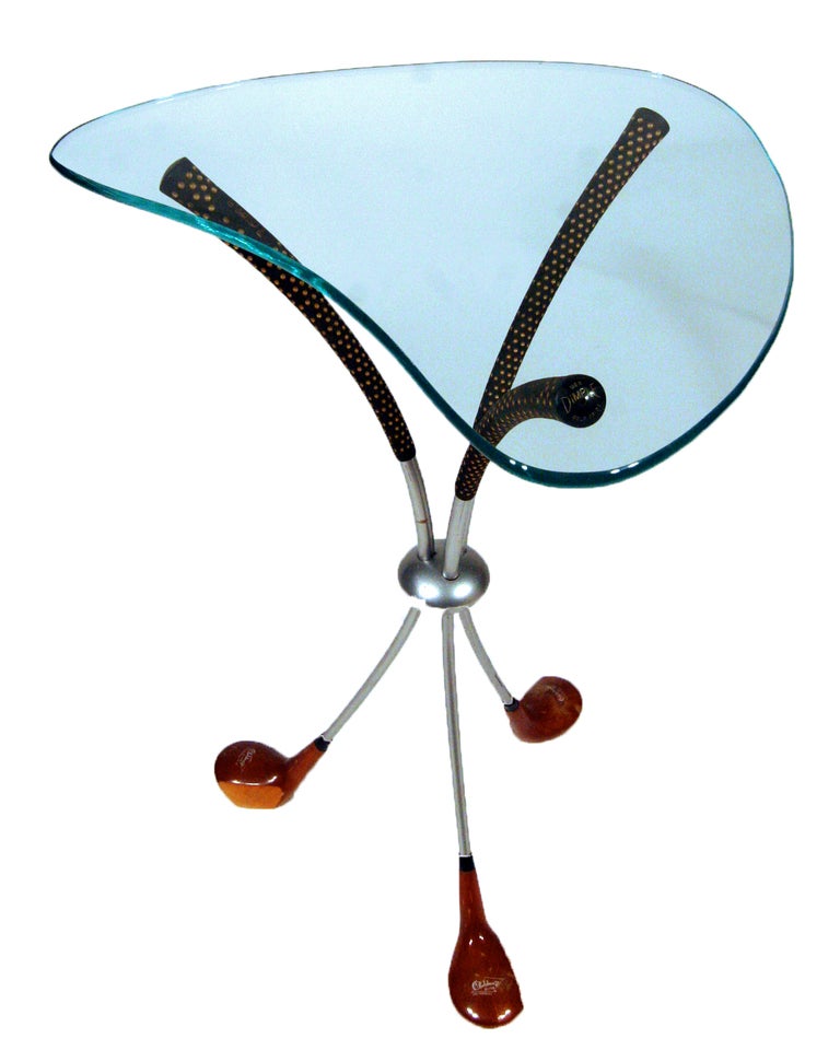 This playful coffee table by Clubhouse Design features a quarter inch thick, biomorphic glass top resting on a base of three real wood driver clubs.

* A matching coffee table is available, please view our 