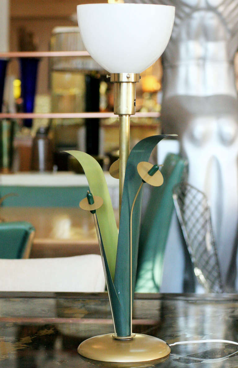 Mid-Century brass torchiere cattail table lamp. Lamp features a brass stem connected to a brass base embellished with enameled green leaf blades and cattails. 

Stamped 