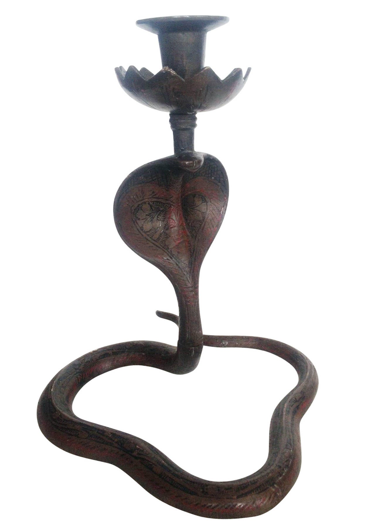 This piece is a pair of bronze cast Indian Cobra Snake candlestick holders. Each cobra is oriented upward and topped with a floral-shaped cup. The bodies are etched with West Asian patterns and decorated with red and black enamel paint.