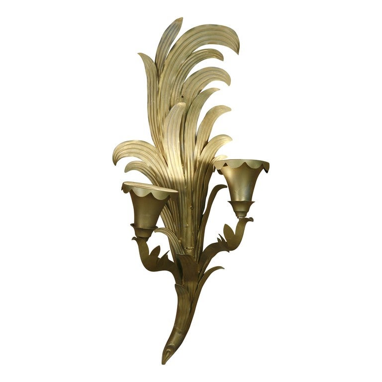 This large-scale Art Deco palm sconce rendered in gilt metal was obtained from the historic May Company department store once located on Wilshire Boulevard in Los Angeles. The grand sconce dates back to 1939.