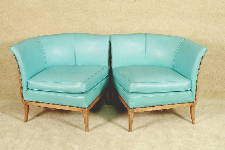 This mid-century modern two-part sectional settee features sculpted legs which taper slightly as well as elegant fan arms. The settee has an oak frame and is upholstered in teal vinyl. Because of its petite size - it is the perfect addition for