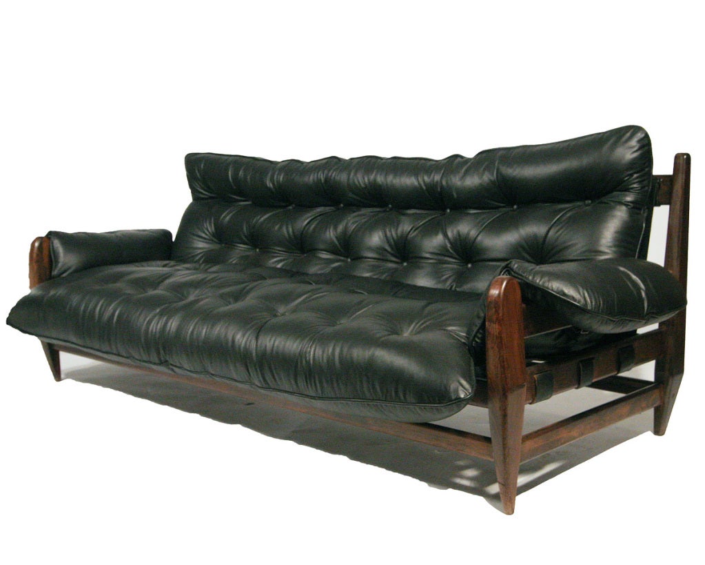 This three-seat rosewood and leather sofa by Sergio Rodrigues which was produced the 1960s 

The wood frame piece is in it's stunning original condition and skillfully reupholstered in softest and most supple black leather available.