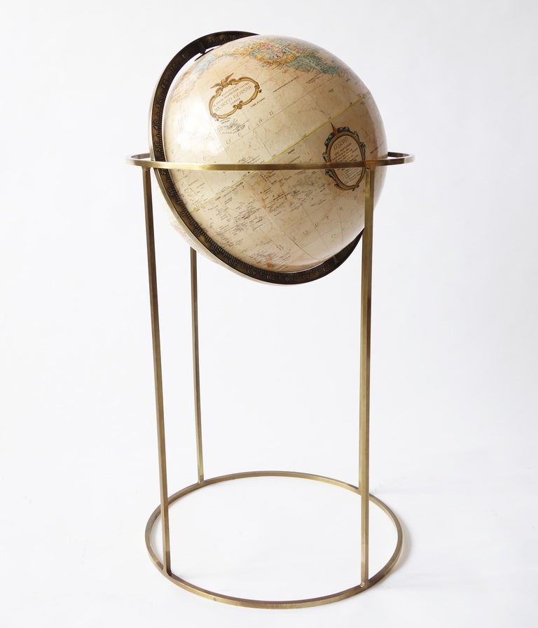 20th century Replogle globe supported in a minimalist brass frame. This particular design has often been attributed to Paul McCobb, probably because of the use of 1/2